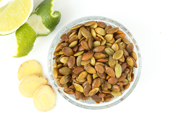 Ginger and lime pumpkin seeds with sliced ginger. Moscow-mule inspired recipe for a healthy snack.
