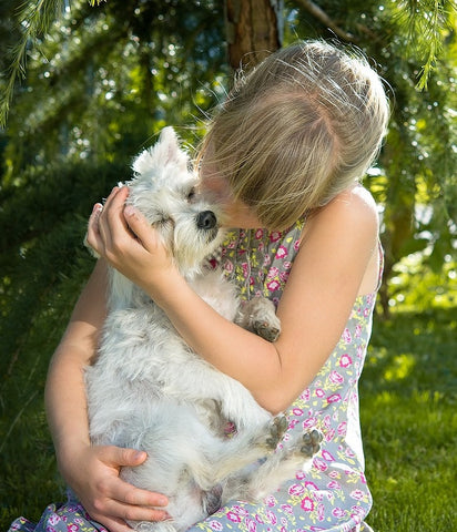girl hugs dog