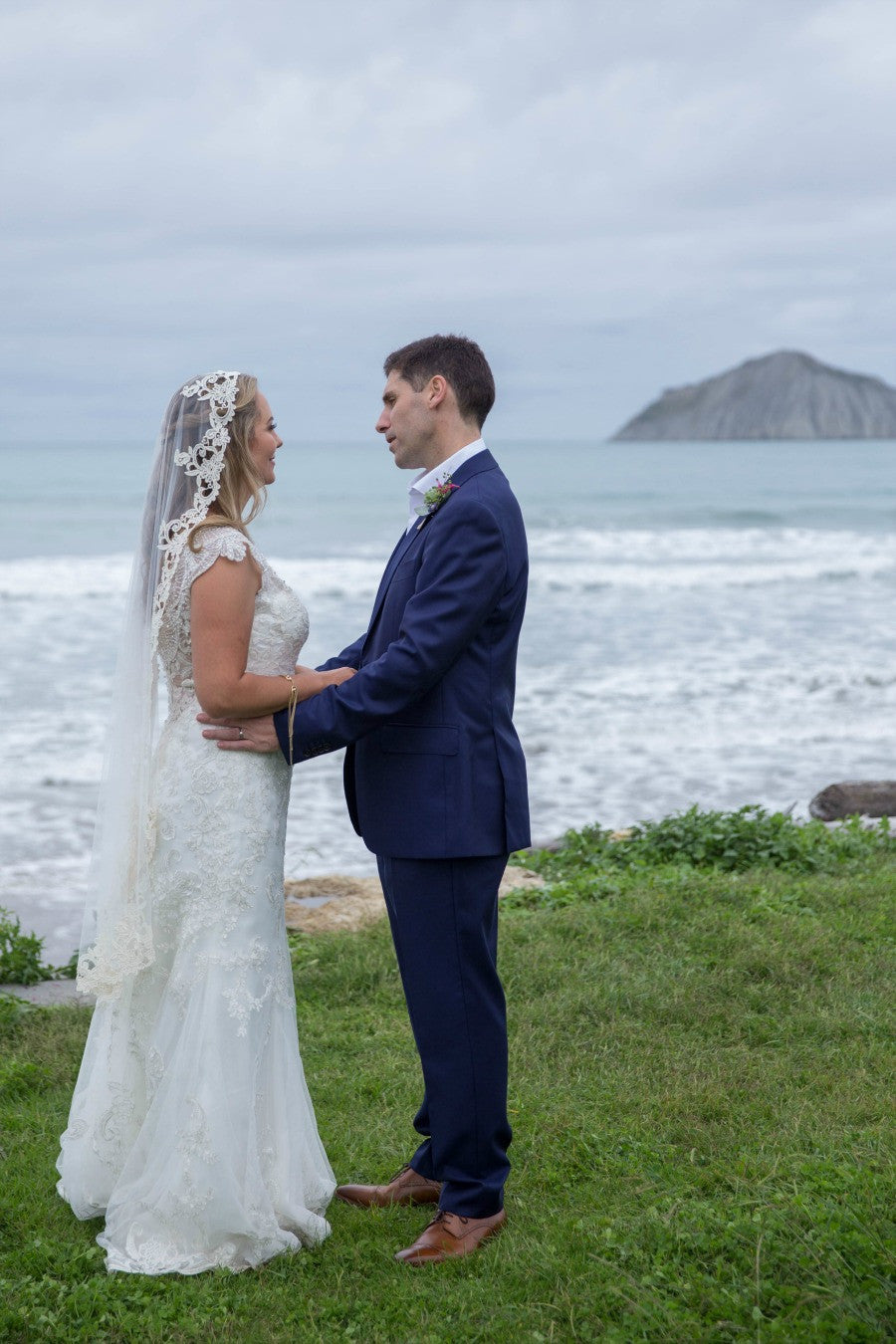 bride and groom new zealand wedding on water with mountains