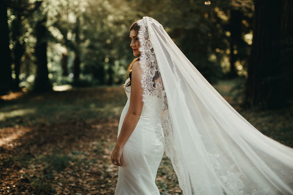 bridal portraits in the woods with long wedding veil