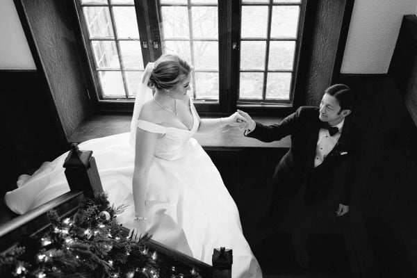 bride and groom walking down the stairs to reception