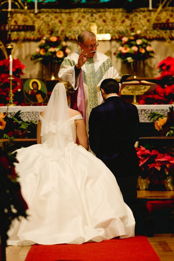 bride and groom recieving blessing