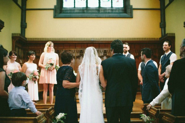 bride walking down aisle with parents