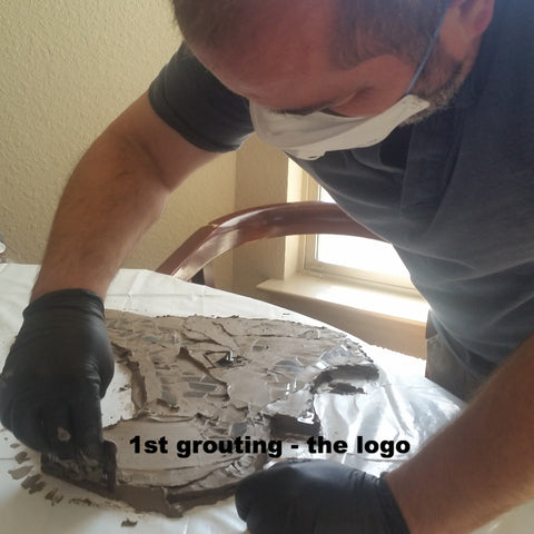 Grouting the mosaic Texans logo