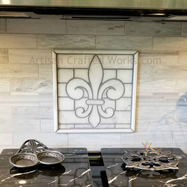 White fleur de lis backsplash medallion crafted from Sahara Carrara Marble.