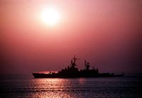 The guided missile cruiser USS BELKNAP (CG 26) is silhouetted against the setting sun as it makes for the Mediterranean. BELKNAP, scheduled along with the Aegis guided missile cruiser USS THOMAS S. GATES (CG 51) and the guided missile frigate USS KAUFFMAN (FFG 59) for a historic visit to the Soviet Black Sea Fleet Headquarters of Sevastopol, was redeployed after the reported murder of Marine Lieutenant Colonel William R. Higgins in Lebanon. - 1989