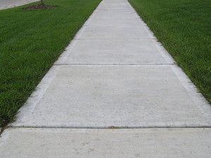 The sidewalk is free of rust stains after using Concrete Rust Remover