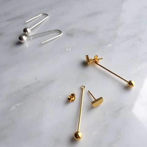 the Petra pendulum drop earrings in sterling silver and the mini d stud drop ball earrings in gold plated, by lines and current this autumn winter 2016.