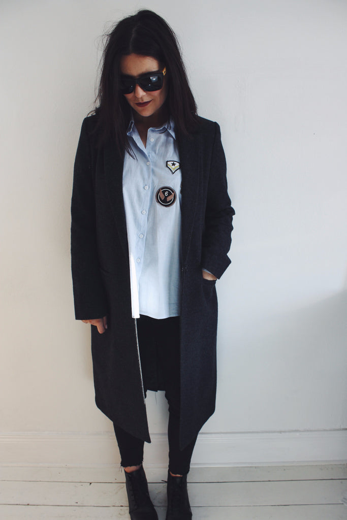 tailored coat over a relaxed fitted shirt