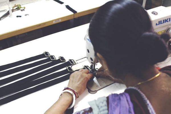 Sewing adjustable straps on to Lines & Current hold-all, hands-free FRIHET bag made by a lady in India