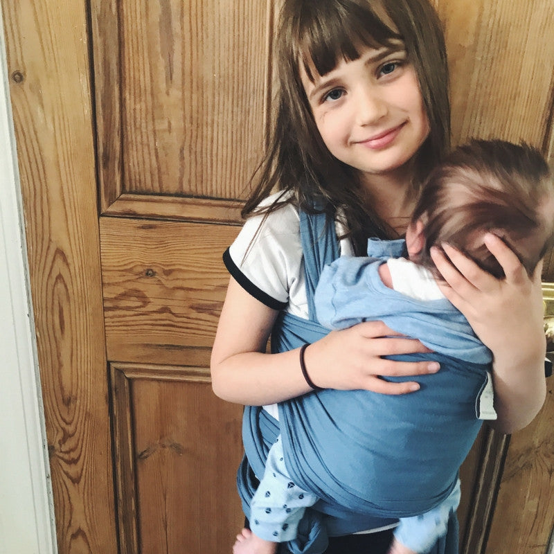 Esmee carrying her brother