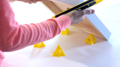 use little triangular painter's stands so the panel would sit off the table top