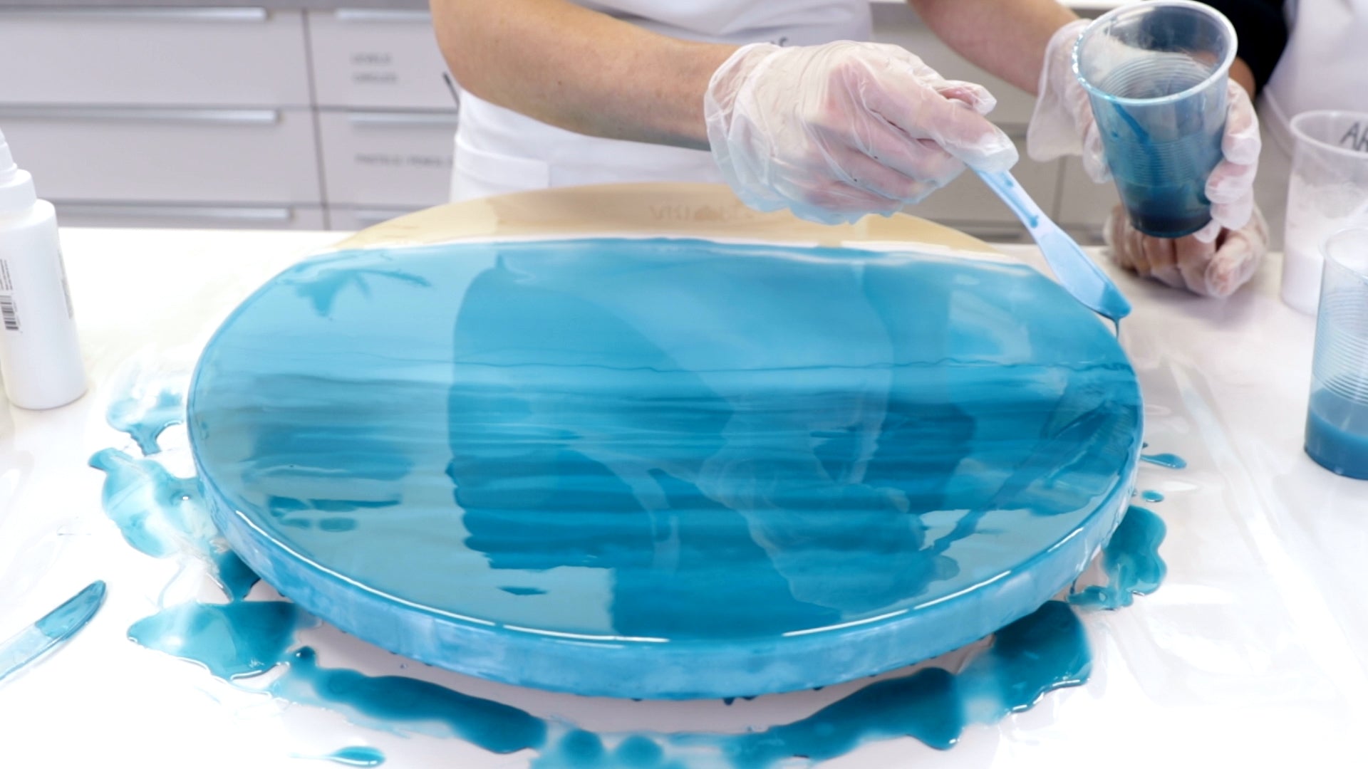 Make Ocean Resin Art - Blend in lines of dark turquoise into the light turquoise