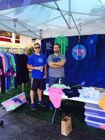 Selling t-shirts at one of the many festivals and street fairs we do every summer.
