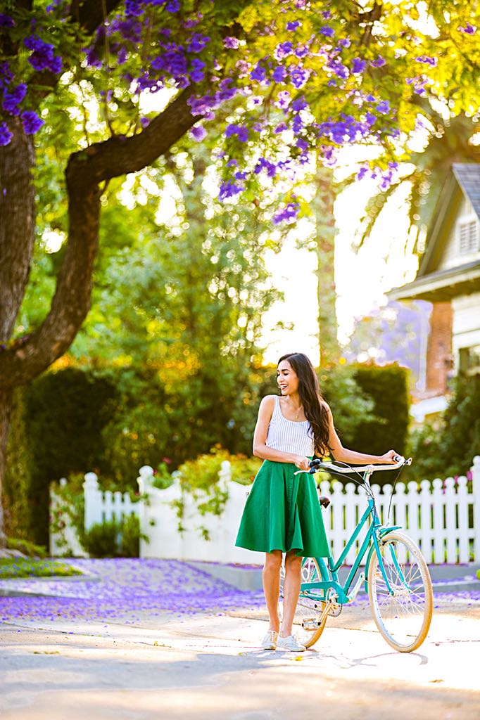 Jessica Rey standing with Brooklyn Bicycle Co. Willow under a tree