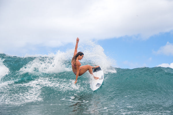 surfer girl shredding the waves 