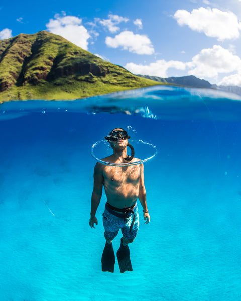 Man snorkeling or free diving in hawaiian waters
