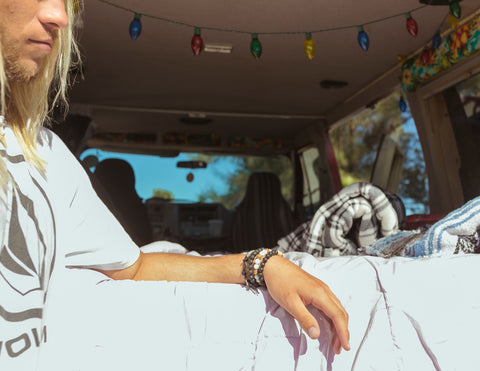 surfer dude wearing mens surf bracelets in hippie van