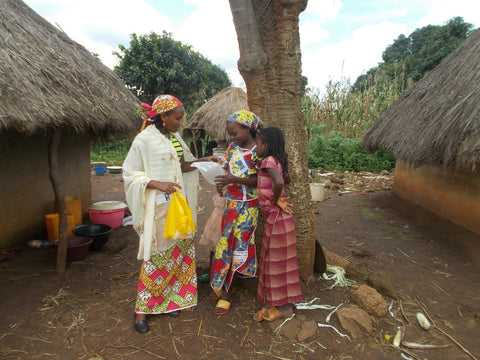 Women in village looking at light.