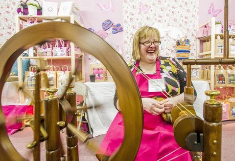 the wooly witch at the Knitting and Stitching show with her spinning wheel