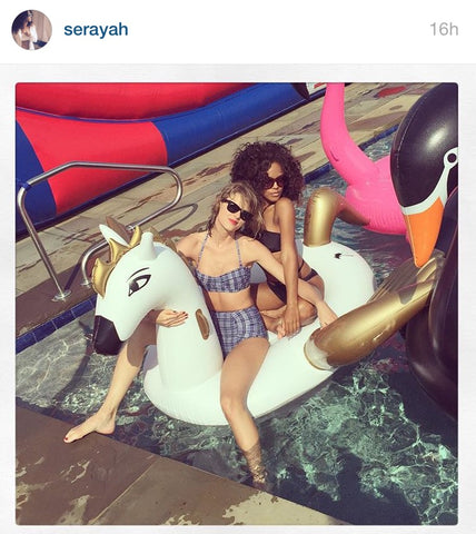 Taylor Swift and Serayah ride the FUNBOY Pegasus float.