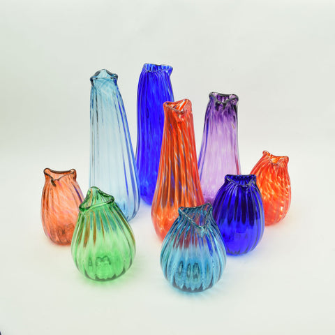 Colorful bud vases in a variety of hues