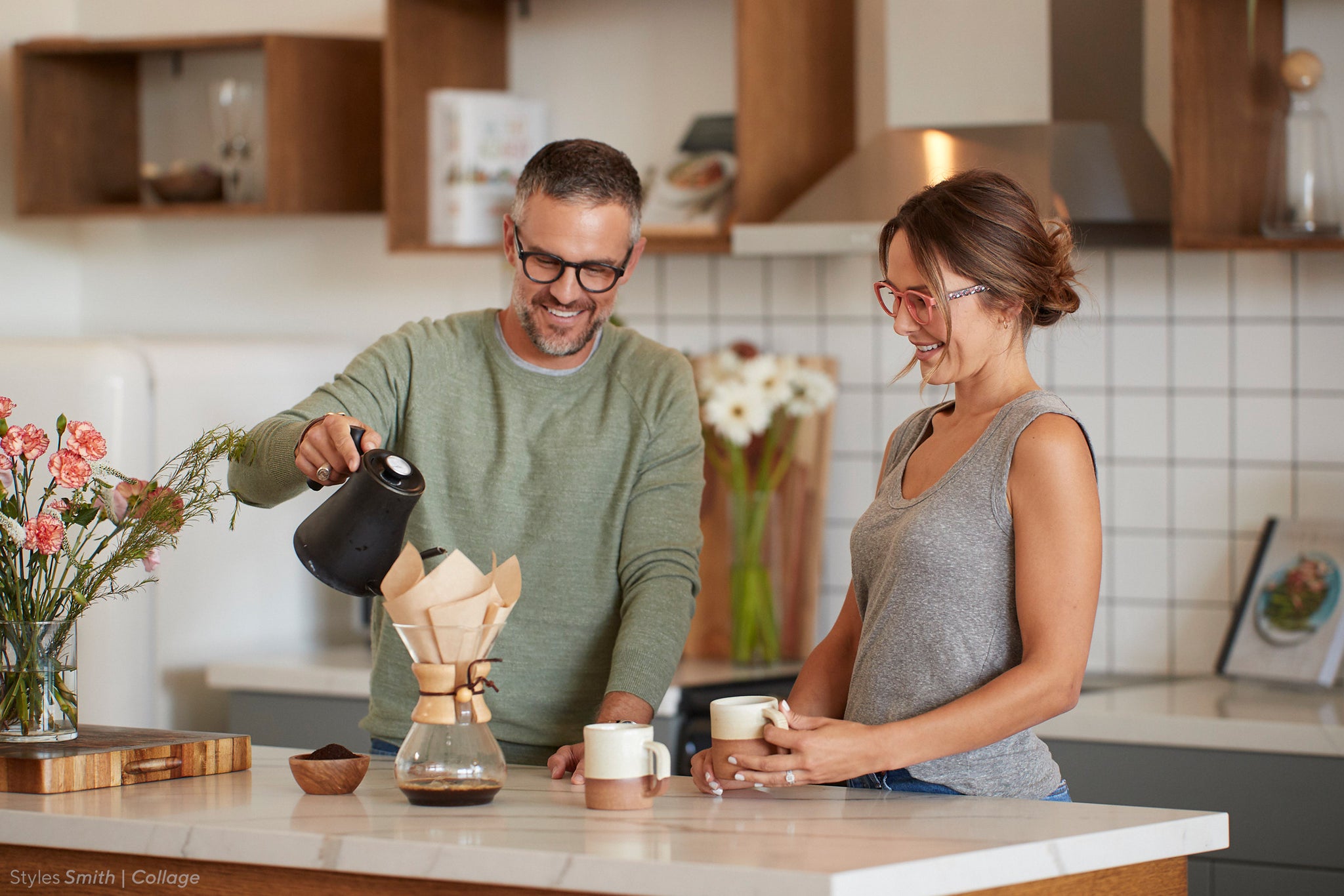 Man and woman brewing coffee in the kitchen wearing Peepers blue light glasses