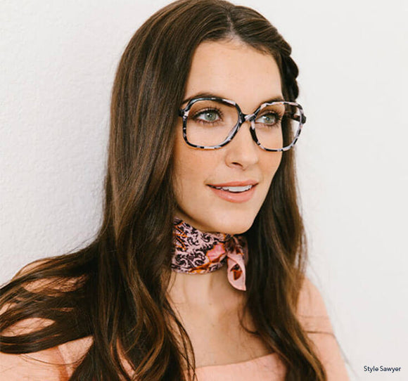Woman wearing Peepers blue light reading glasses