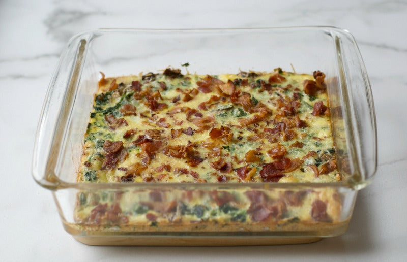 Low carb bacon spinach and cheese egg casserole is a great make ahead dish that's low on carbs and high on flavor. Great brunch recipe! #brunch #recipes #lowcarb #keto #ketodiet #casserole #breakfastcasserole