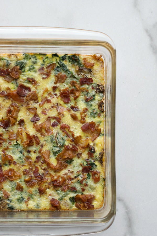 Low carb bacon spinach and cheese egg casserole is a great make ahead dish that's low on carbs and high on flavor. Great brunch recipe! #brunch #recipes #lowcarb #keto #ketodiet #casserole #breakfastcasserole