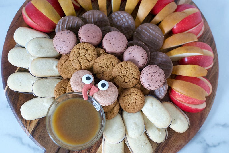 Super easy and tasty Turkey Dessert Board to serve at a Thanksgiving dinner! With crunchy fruit, homemade caramel dipping sauce and favorite store bought cookies there's something for everyone! #Thanksgivingdesserts #dessertboard #glutenfree #dessertrecipes #Thanksgivingdinner 