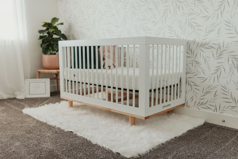 White crib set up in baby room