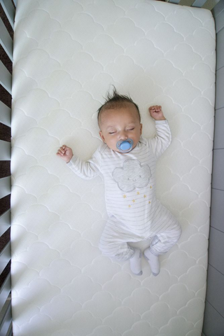 baby sleeping on non-toxic crib mattress
