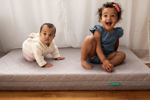 two babies on a Newton Baby crib mattress