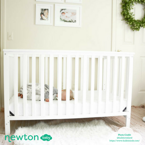 baby sleeping in crib in nursery