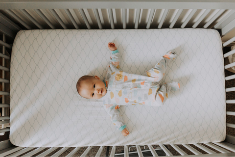 baby laying in a crib