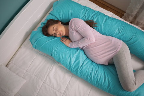 top view of woman with pregnancy pillow