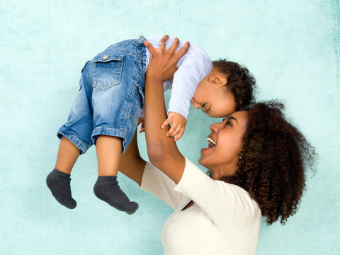 mom holding baby boy over her head