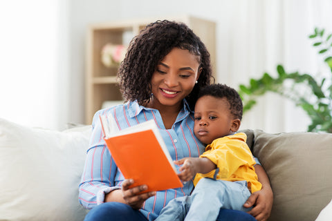 mom reading a book to her baby boy during a sleep regression