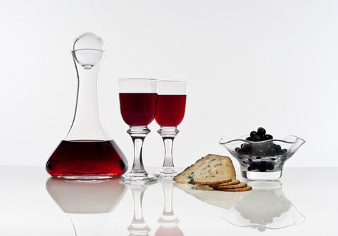 Picture of a wine decanter and two clear short stem wine glasses