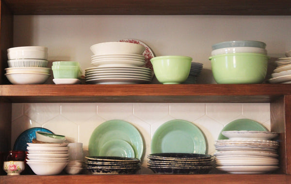 jadeite and vintage dishes on open kitchen shelving