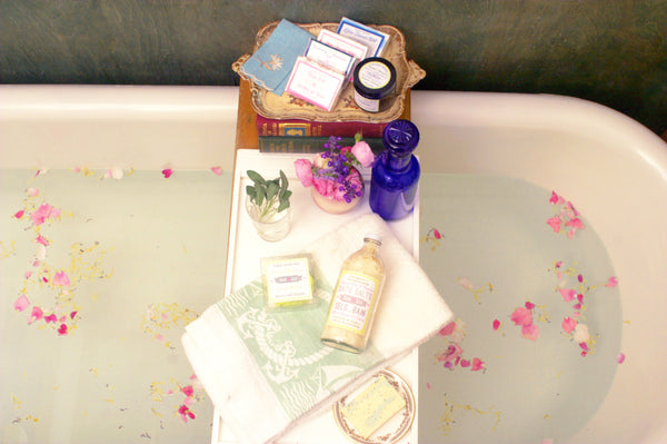 antique bathtub with vintage apothecary products