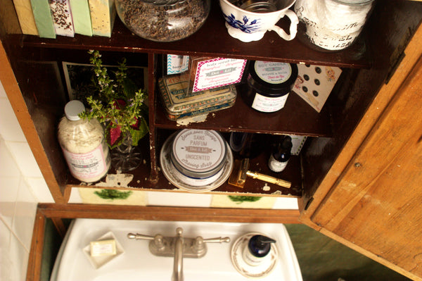 vintage beauty apothecary cabinet in a romantic bathroom