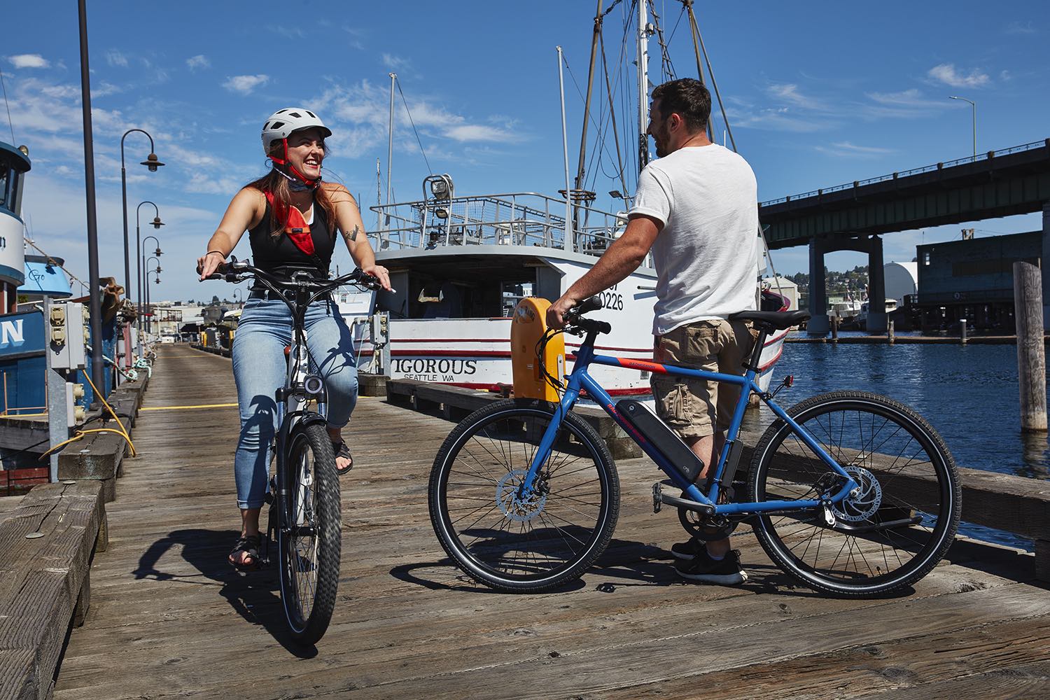 RadCity and RadMission riders talk along a seaside dock.