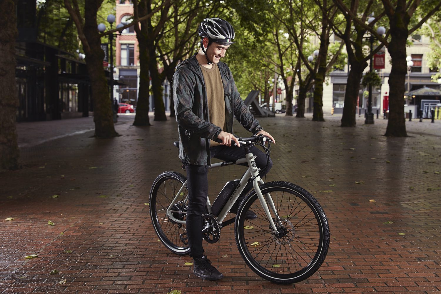 A man pauses in a plaza to admire his RadMission electric bike.