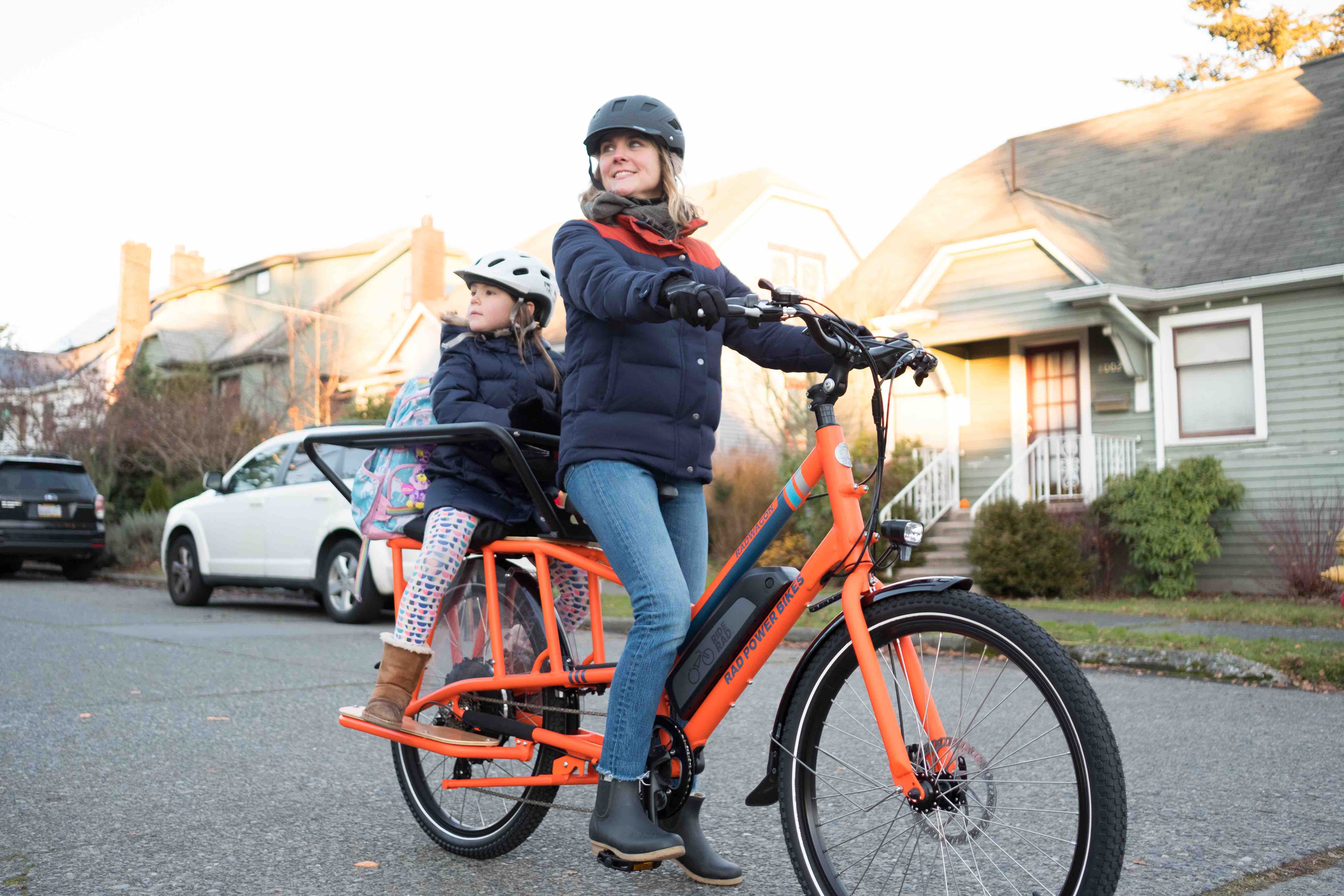A mother rides with her child on a RadWagon.