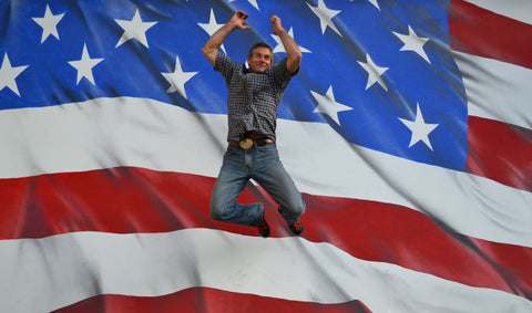 Founder Olie jumping in front of American Flag!