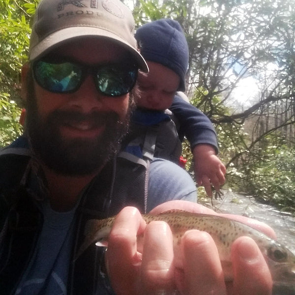 Ryan Kaufman, fly fishing guide Headwaters Outfitters with child