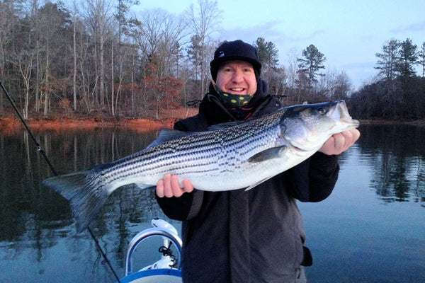 Flymen Fishing Company CEO Martin Bawden with a striped bass