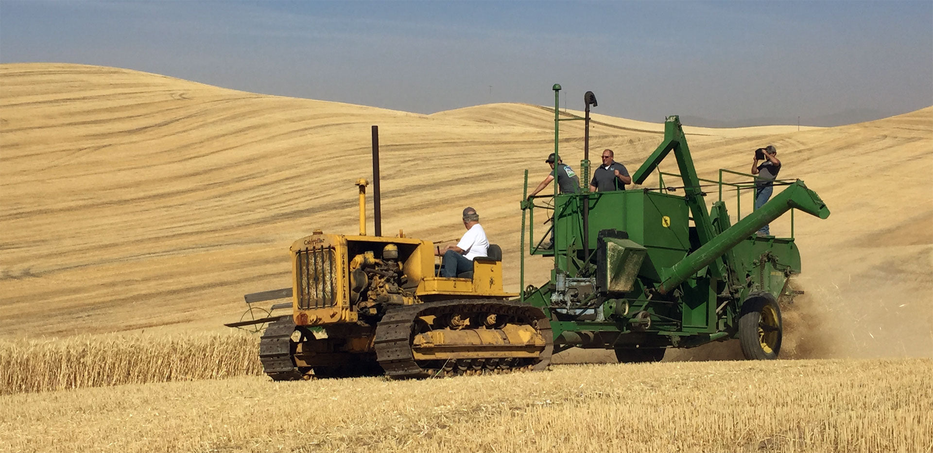 Pull tractor harvesting wheat on the Palouse.